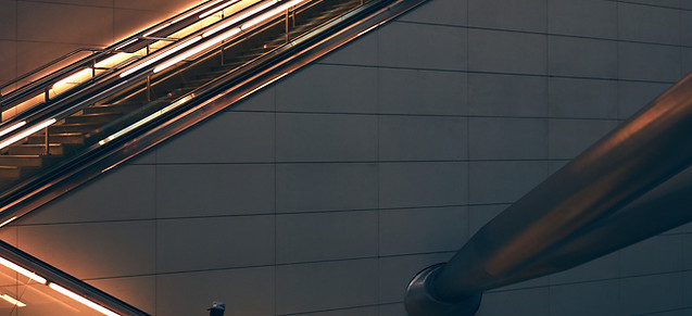 two-person-standing-escalator.jpg