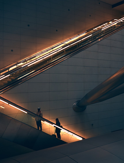 two-person-standing-escalator.jpg